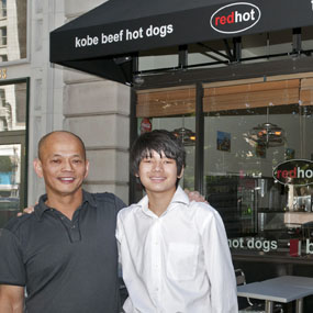 Francis Liong, owner of both Lamb's Grill and the new RedHot hotdog and banh mi on Main Street with his son Logan in front of RedHot.
