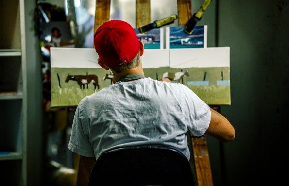 Jeff Pugh paints a landscape in his studio