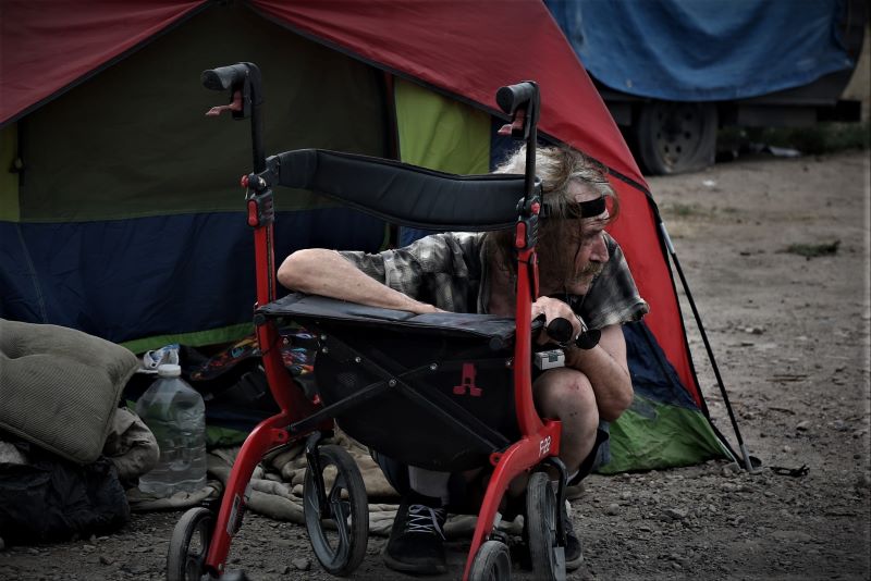 Frank, a homeless man, a victim of yet another abetment that took place on August 4, 2022. Frank is trying to fix his walker while police and the health depertment are clearing the camp. Photo credit Robin Pendergrast.