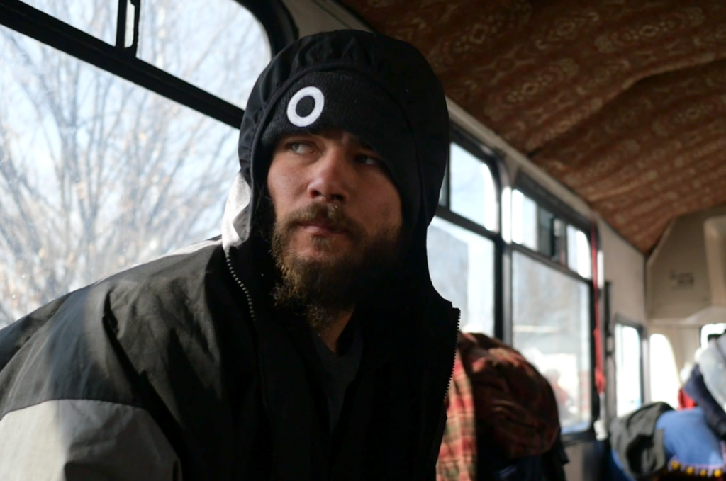 Jared, an unsheltered homeless man, getting warm last February on the Nomad Alliance bus. Jared told Utah Stories he would like to get off the streets and into a job program.