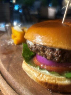 Picanha Burger served at Fogo de Chão in Salt Lake City with smoked provolone, tomato, onion, lettuce, and chimichurri aioli.