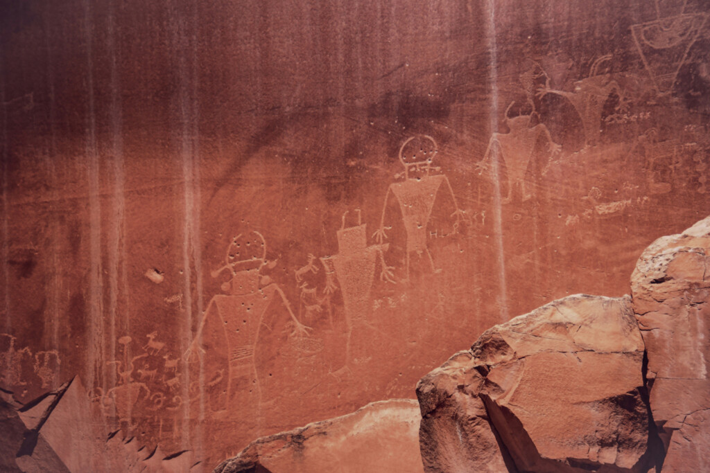 Fremont-style human figures carved into a red sandstone wall in Utah